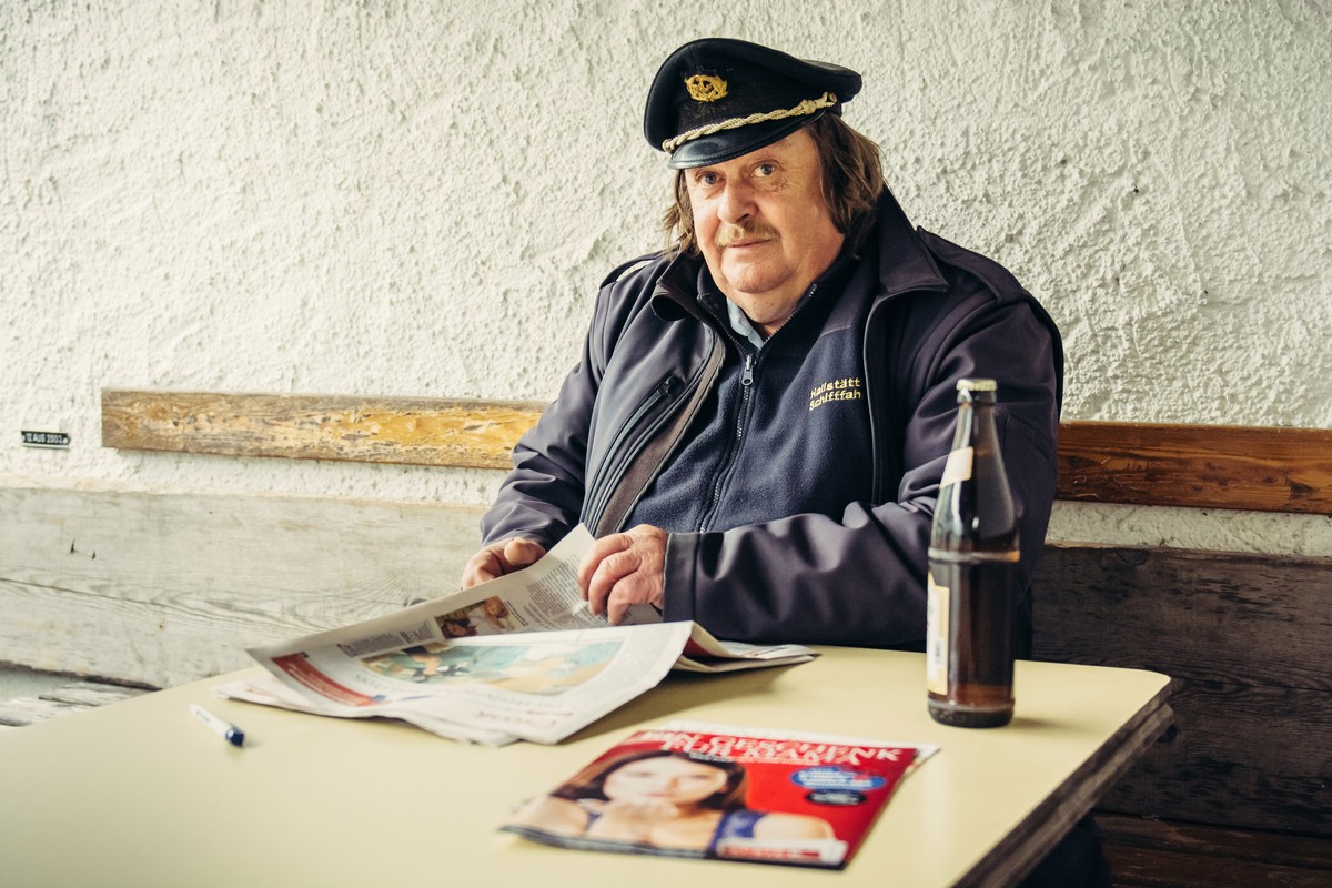 HALLSTATT, AUSTRIA - MAY 03, 2014: Captain of the ferry on mountain lake Hallstatt during the break in Alps