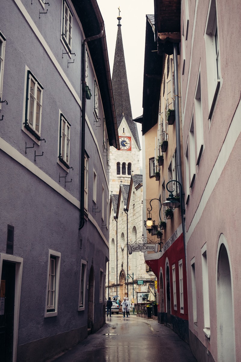 HALLSTATT, AUSTRIA - MAY 03, 2014: Narrow street to the church in Hallstatt, Austria. This historical village in Austrian Alps at the Hallstatter lake and promoted by UNESCO World Heritage region.